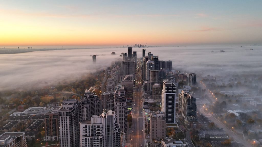 North York - Yonge Street - Distant CN Tower View before sunrise shot taken from my drone on a cool misty morning of the Autumn season - Oct-2022